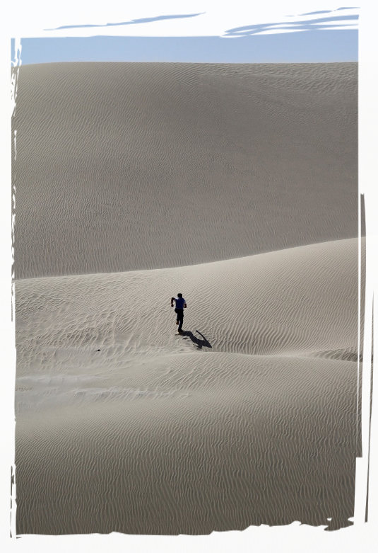 Person running across the desert